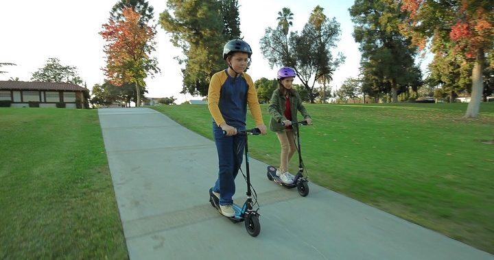 two kids riding scooters