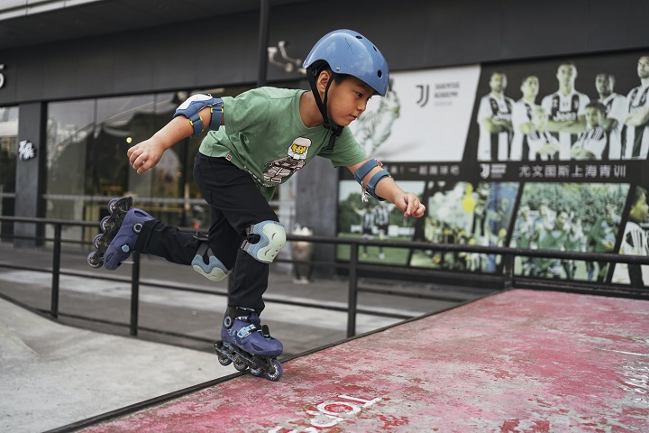 picture of a boy on rollerblades in a skate park