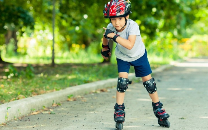 picture of a boy riding roller blades in the park