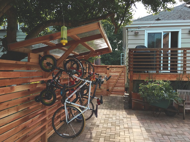 bicycles on garden bike rack on wooden fence 