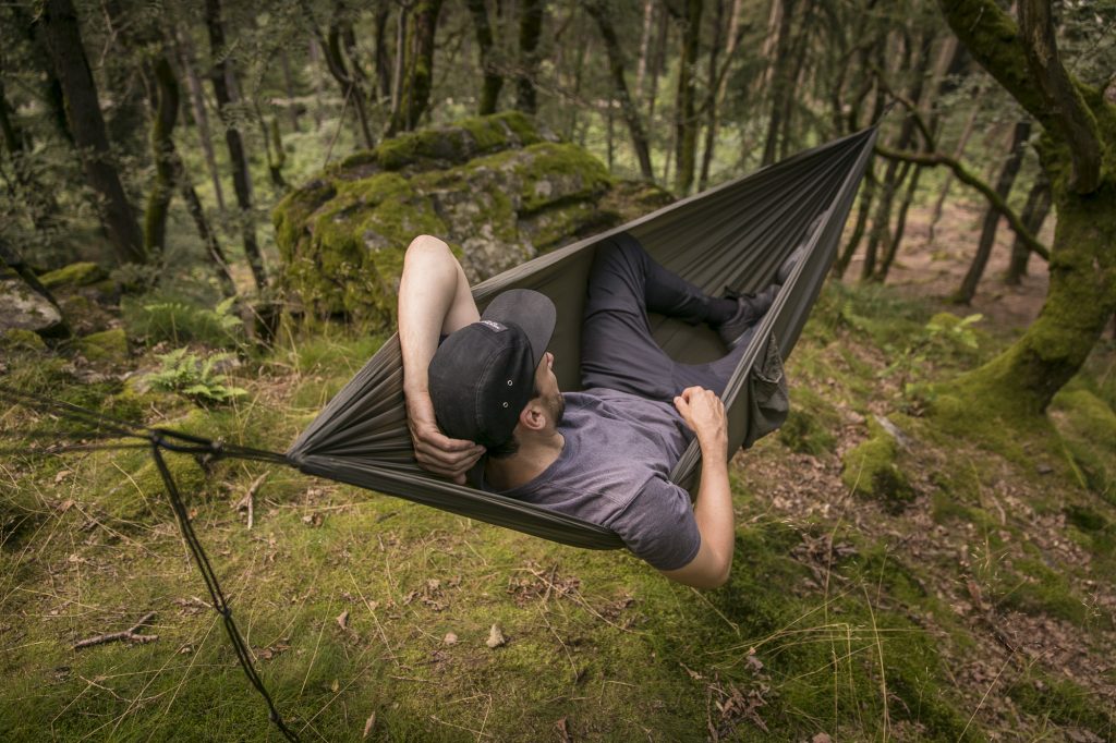 Man laying in a jungle hammock