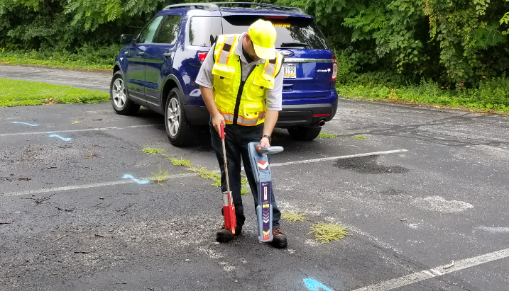Man working with underground cable locator