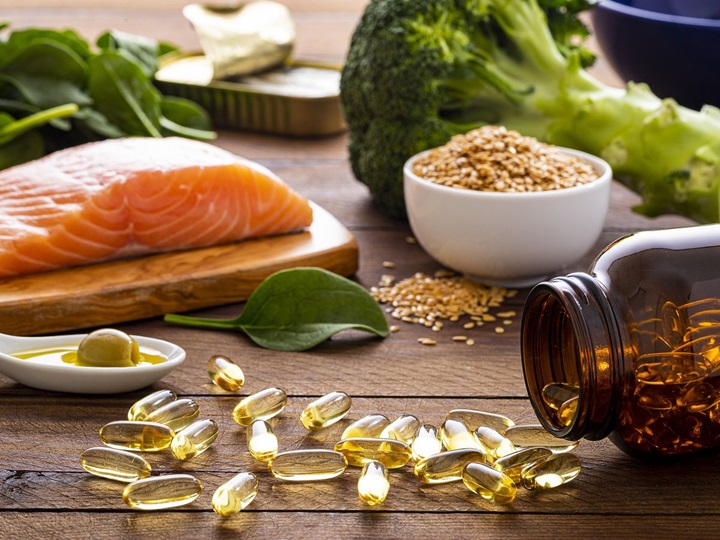 salmon, seeds and amino acid capsules spread all over a table 