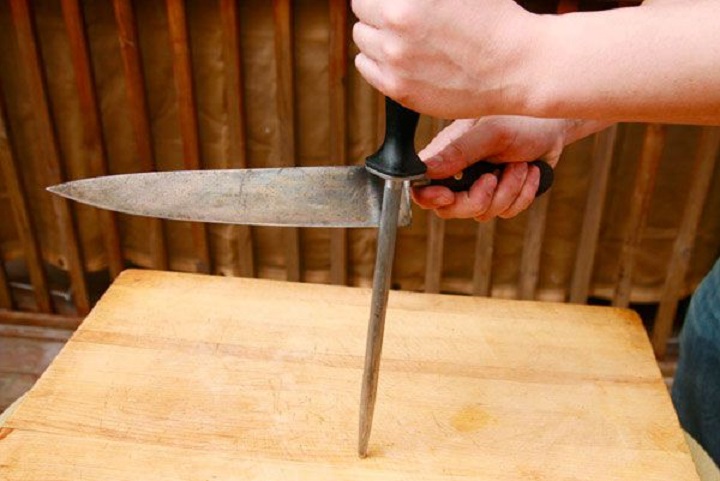 person honing a knife 