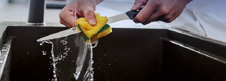 person cleaning a knife 