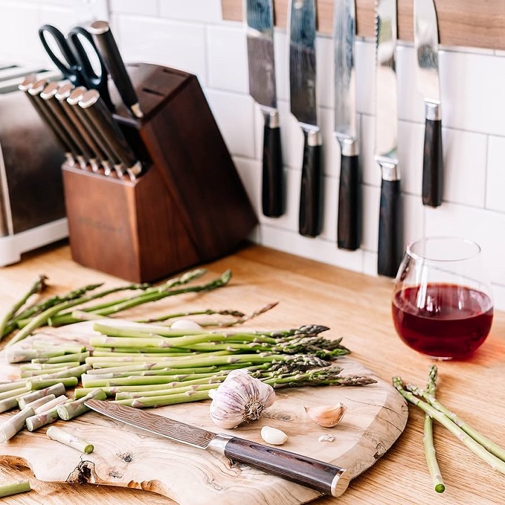 knifes in a kitchen with food and wine