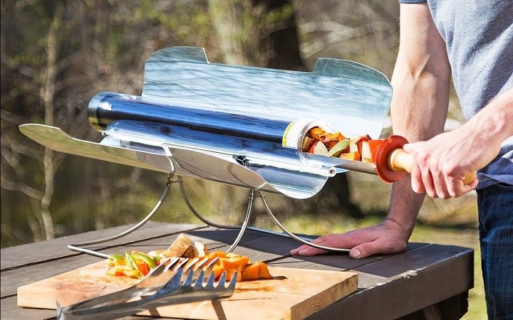 Man cooking in solar oven
