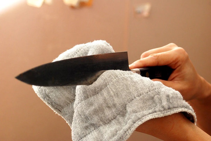 person drying knife  