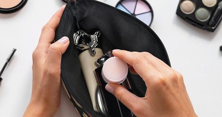 woman organizing her makeup in a makeup bag